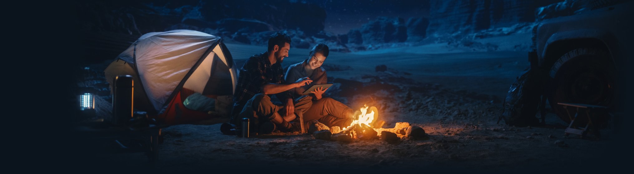 Mensch, der in der Natur auf seinem Tablet arbeitet.