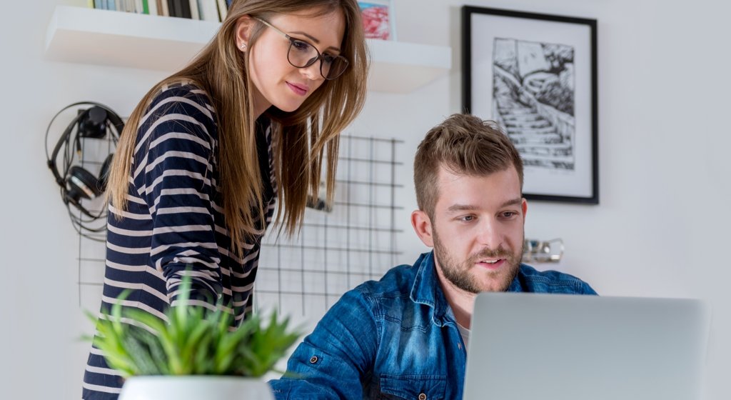 Zwei Personen, die nauf ein Notebook schauen.